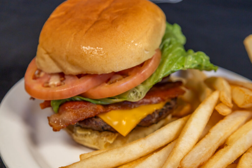 Burger with bacon, cheese, and fries